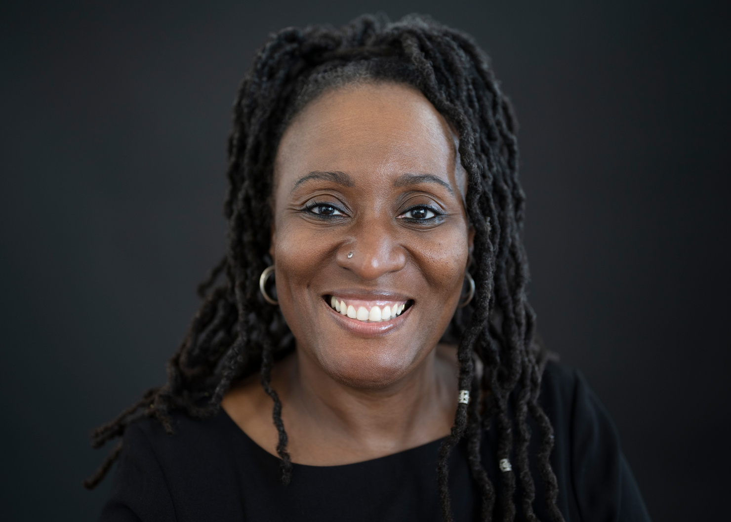 Front view portrait of cheerful middle-aged black woman